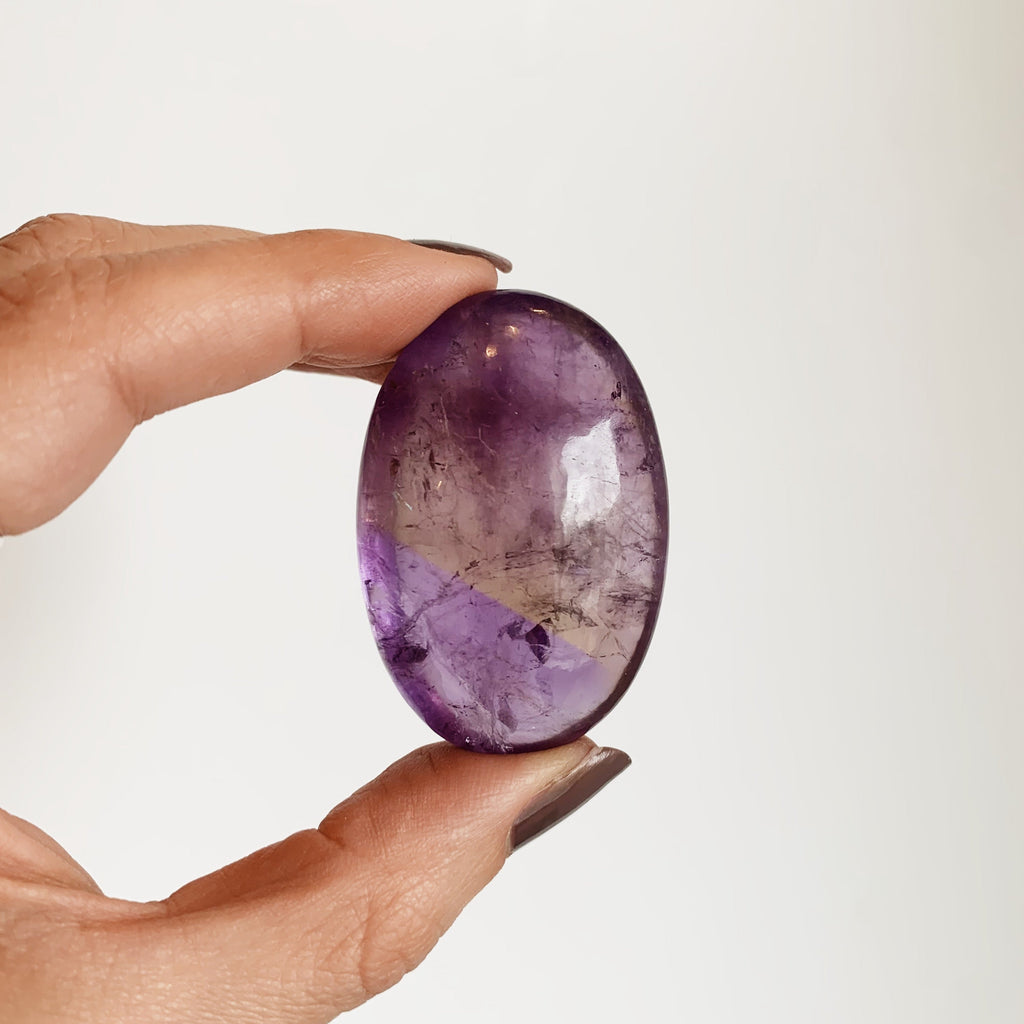 Small purple and yellow Ametrine palm stone
