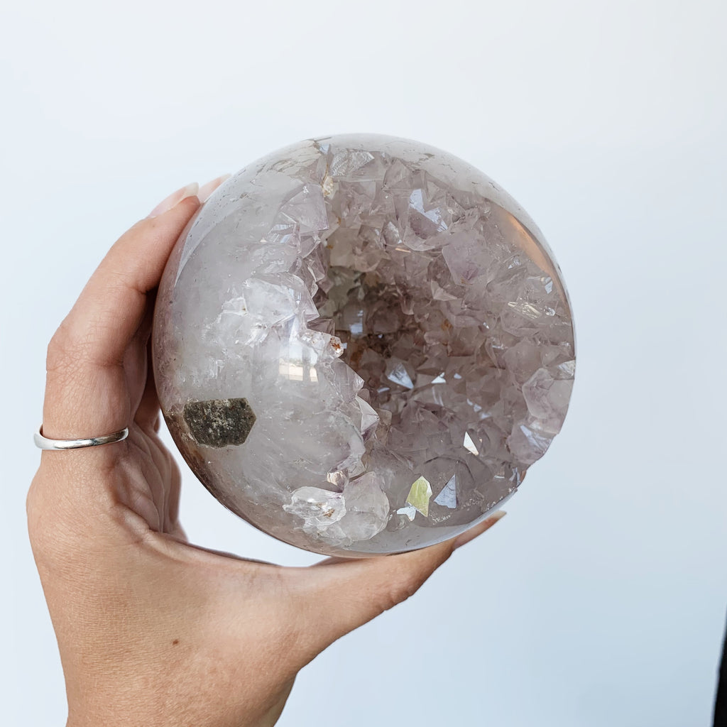 Polished Amethyst Geode with exposed internal points
